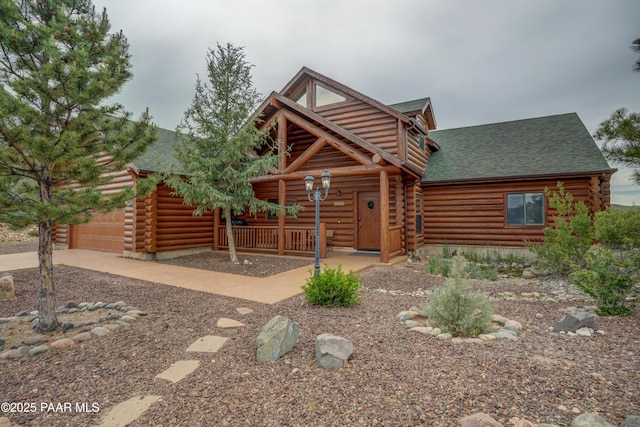 1070 Quiet Pines Ln, Prescott, AZ 86303 - log home featuring a shingled roof, log exterior, concrete driveway, and an attached garage