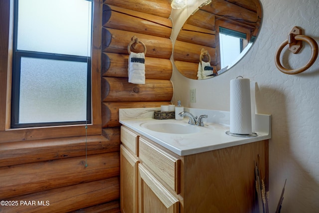 1070 Quiet Pines Ln, Prescott, AZ 86303 - bathroom featuring vanity, a textured wall, and log walls