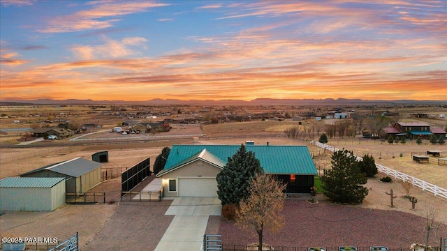 25860 N Cabernet Ln, Paulden, AZ 86334 - view of front of property featuring a garage, concrete driveway, an outdoor structure, a metal roof, and a mountain view