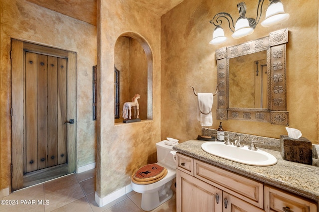 12390 E Triple T Ln, Prescott Valley, AZ 86315 - bathroom with toilet, vanity, and tile patterned floors
