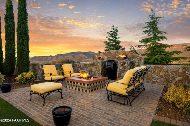 12390 E Triple T Ln, Prescott Valley, AZ 86315 - patio terrace at dusk with a mountain view and an outdoor fire pit
