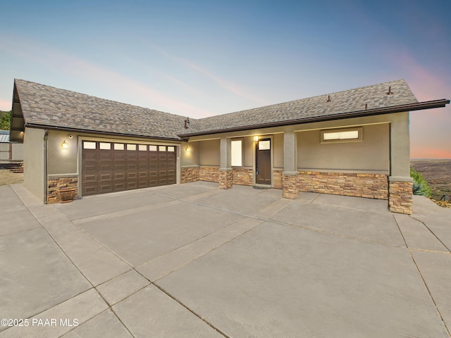 15606 E Sterling Spur Rd, Dewey-Humboldt, AZ 86327 - ranch-style home with concrete driveway, stone siding, a shingled roof, a garage, and stucco siding