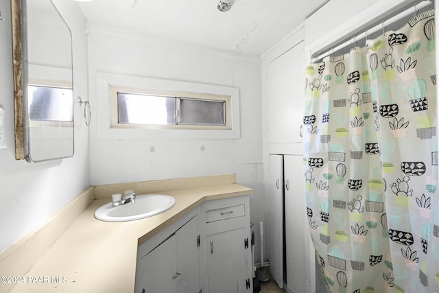 bathroom featuring vanity and a shower with shower curtain