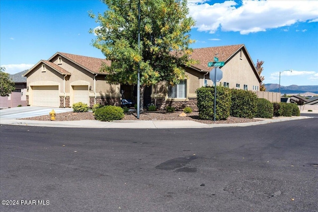 view of front of home with a mountain view and a garage