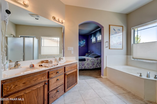 3096 Adobe Springs Dr, Prescott, AZ 86301 - bathroom with a bath, ensuite bathroom, double vanity, tile patterned floors, and a stall shower