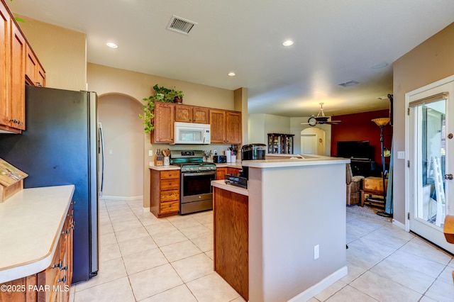 3096 Adobe Springs Dr, Prescott, AZ 86301 - kitchen featuring stainless steel appliances, arched walkways, a peninsula, a ceiling fan, and light countertops