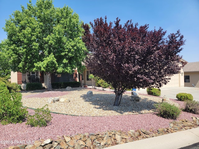 3096 Adobe Springs Dr, Prescott, AZ 86301 - obstructed view of property with stucco siding, an attached garage, and driveway