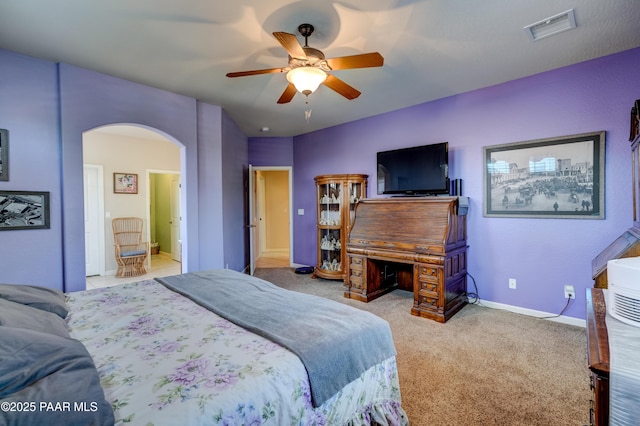 3096 Adobe Springs Dr, Prescott, AZ 86301 - bedroom featuring arched walkways, carpet flooring, ceiling fan, and ensuite bathroom