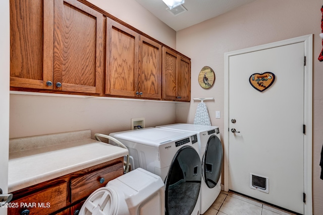 3096 Adobe Springs Dr, Prescott, AZ 86301 - laundry room with cabinet space, washer and clothes dryer, and light tile patterned flooring