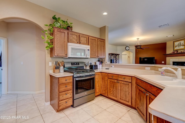 3096 Adobe Springs Dr, Prescott, AZ 86301 - kitchen featuring stainless steel gas range, white microwave, a ceiling fan, light countertops, and light tile patterned flooring