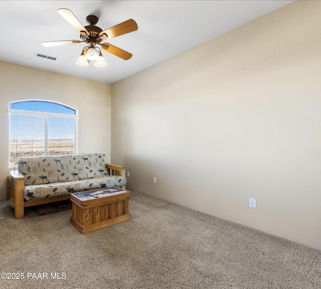 unfurnished living room featuring carpet flooring and ceiling fan