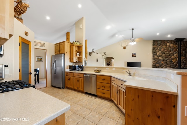 kitchen featuring vaulted ceiling, stainless steel appliances, kitchen peninsula, light tile patterned flooring, and ceiling fan