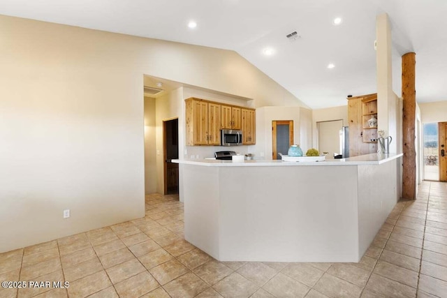 7889 E Dog Ranch Rd, Prescott Valley, AZ 86315 - kitchen with stainless steel appliances, lofted ceiling, light tile patterned floors, light countertops, and a peninsula