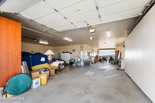 garage with water heater and a garage door opener