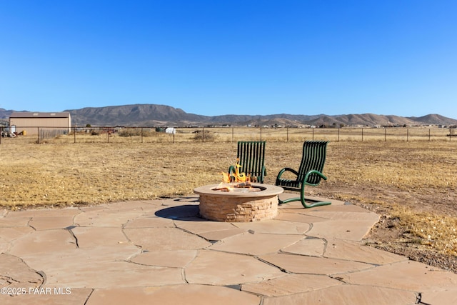 view of patio / terrace featuring a mountain view and a fire pit