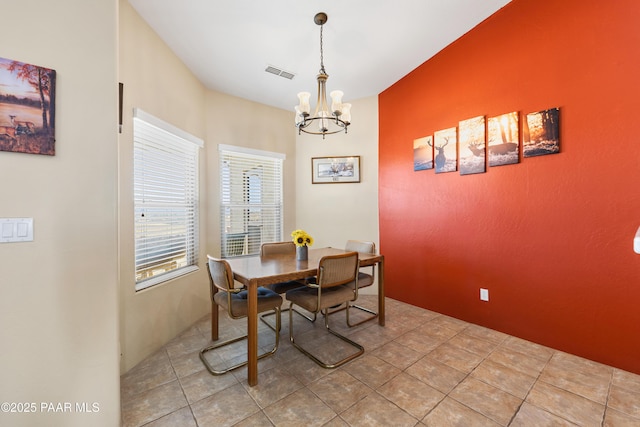 dining room featuring light tile patterned floors and a chandelier