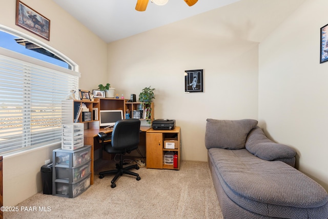 office area featuring ceiling fan, light colored carpet, and vaulted ceiling