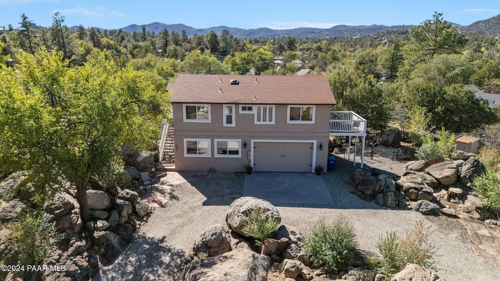 view of front of property with a mountain view and a garage