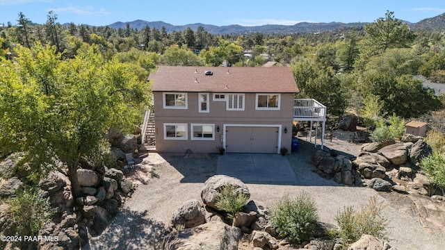 view of front of property with a mountain view and a garage