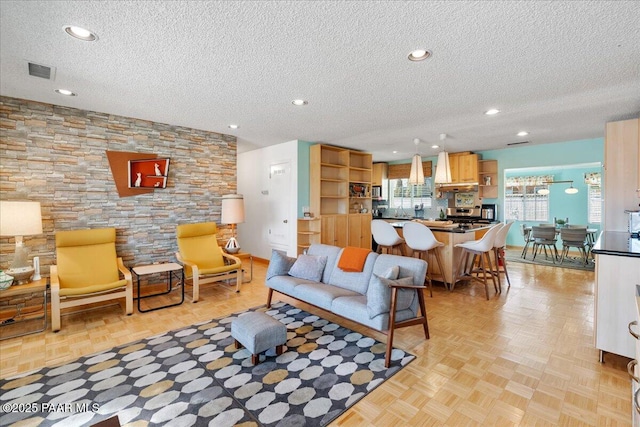 living room featuring light parquet floors and a textured ceiling