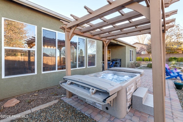 view of patio with a hot tub and a pergola