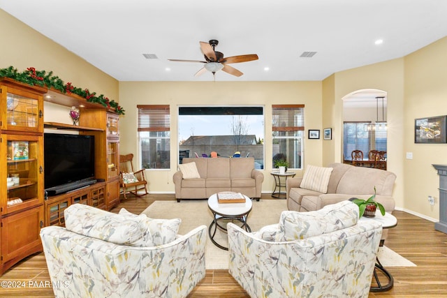 living room with ceiling fan and light wood-type flooring