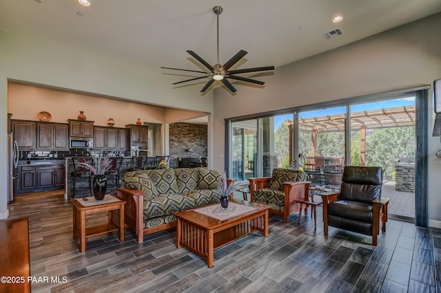 892 Canyon Breeze Ct, Prescott, AZ 86303 - living area with visible vents, dark wood-style flooring, ceiling fan, and high vaulted ceiling