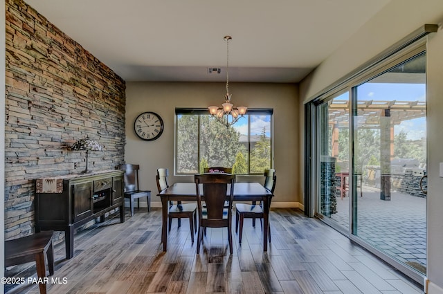 892 Canyon Breeze Ct, Prescott, AZ 86303 - dining room featuring a notable chandelier, wood finished floors, and a wealth of natural light