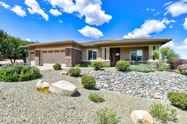 892 Canyon Breeze Ct, Prescott, AZ 86303 - prairie-style home featuring covered porch, an attached garage, stone siding, and stucco siding