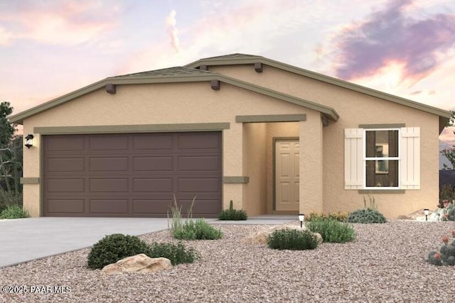 view of front facade with driveway, a garage, and stucco siding