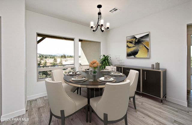 dining area featuring a chandelier and light hardwood / wood-style floors