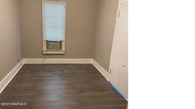 unfurnished room featuring cooling unit and dark hardwood / wood-style flooring