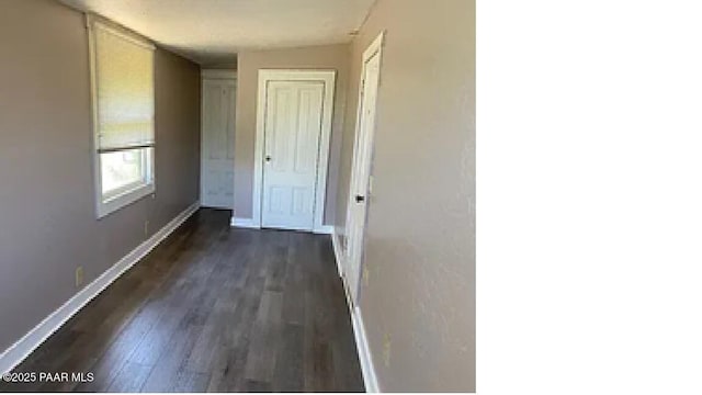 hallway with dark hardwood / wood-style floors