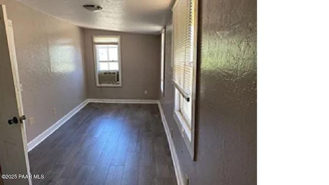 unfurnished room with dark hardwood / wood-style floors and cooling unit