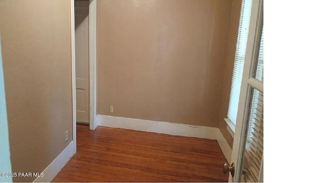 unfurnished room featuring hardwood / wood-style flooring