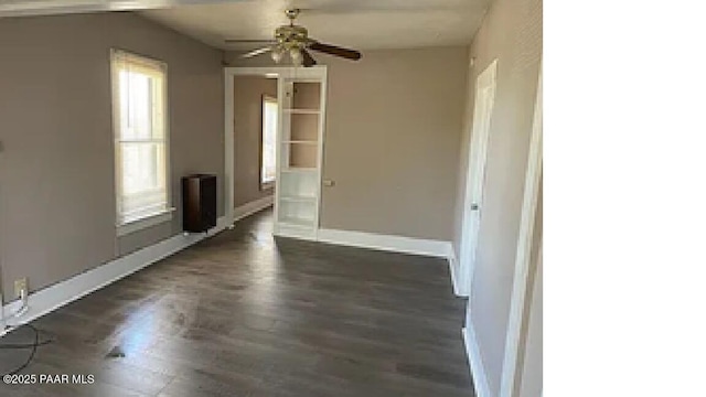 unfurnished room featuring dark hardwood / wood-style flooring and ceiling fan