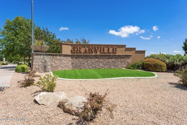 community sign featuring a lawn