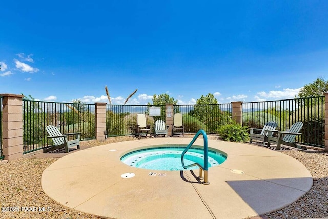 view of pool featuring a hot tub and a patio area