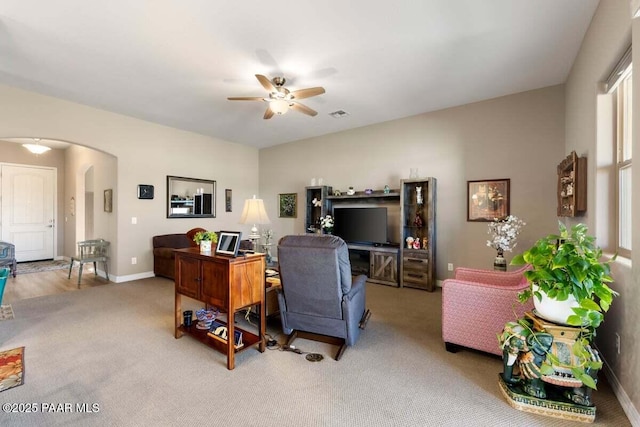 carpeted home office with ceiling fan