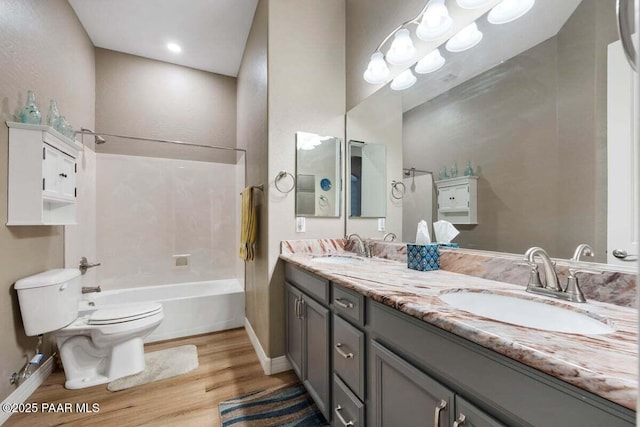 full bathroom with vanity, hardwood / wood-style flooring, shower / tub combination, and toilet