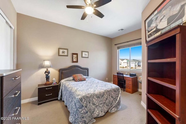 carpeted bedroom featuring ceiling fan and a closet