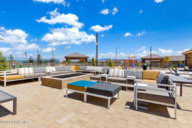 view of patio featuring a gazebo and an outdoor living space with a fire pit