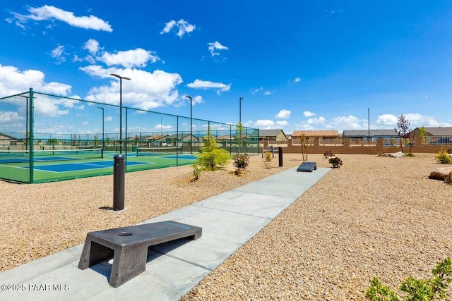 view of property's community with tennis court