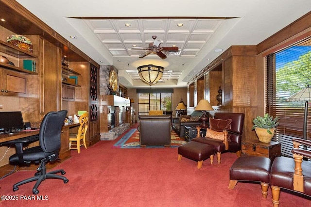 carpeted office space with beamed ceiling, coffered ceiling, a wealth of natural light, and wood walls