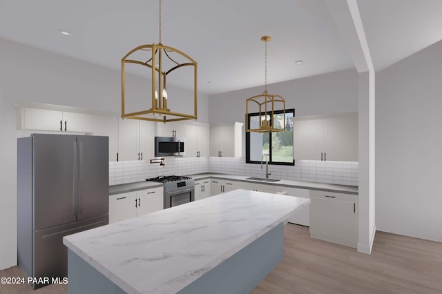 kitchen with appliances with stainless steel finishes, sink, light hardwood / wood-style flooring, white cabinets, and hanging light fixtures