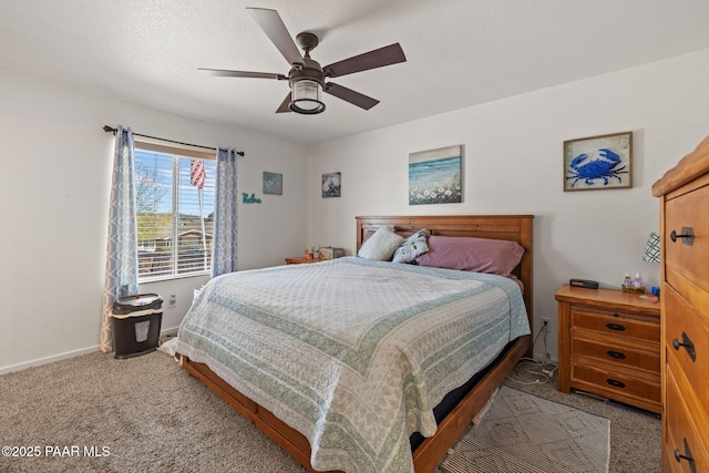 carpeted bedroom featuring ceiling fan and baseboards
