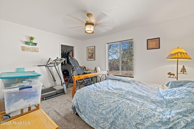 bedroom featuring a spacious closet, a ceiling fan, carpet flooring, and a closet