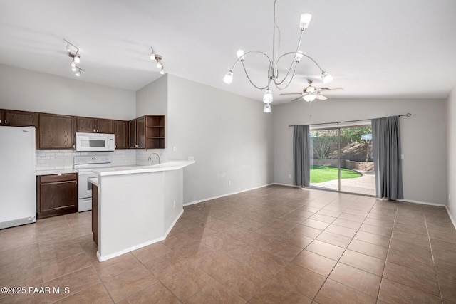 3713 W Nancy Ln, Phoenix, AZ 85041 - kitchen with white appliances, open shelves, open floor plan, vaulted ceiling, and light countertops