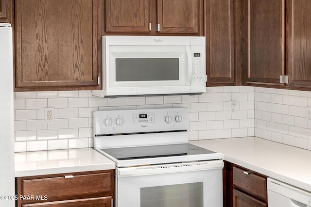 3713 W Nancy Ln, Phoenix, AZ 85041 - kitchen with white appliances, tasteful backsplash, light countertops, and dark brown cabinetry