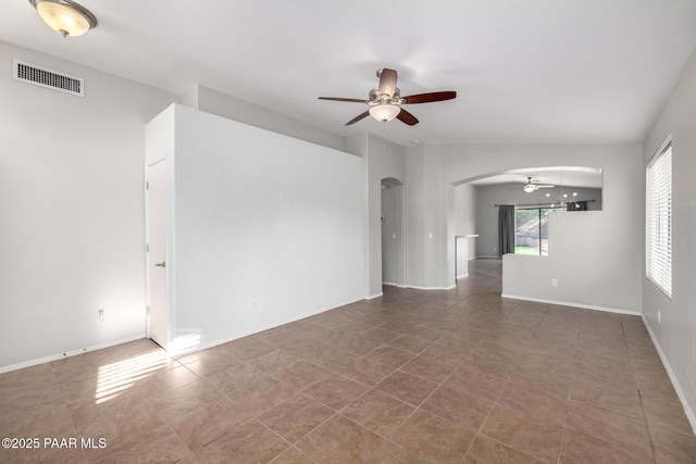 3713 W Nancy Ln, Phoenix, AZ 85041 - empty room with arched walkways, ceiling fan, and tile patterned flooring